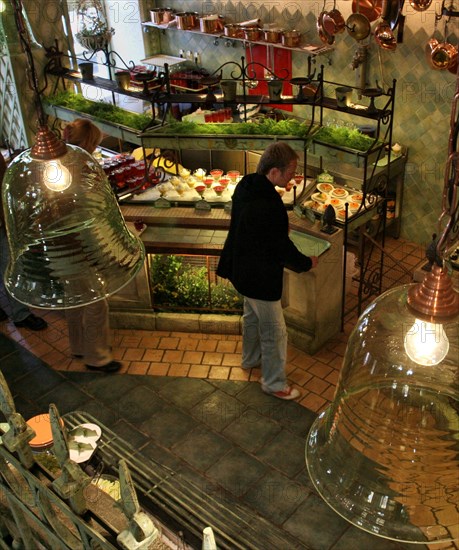 A guest chooses desserts at moscow's grabli (rake) restaurant, moscow, russia, september 2006.