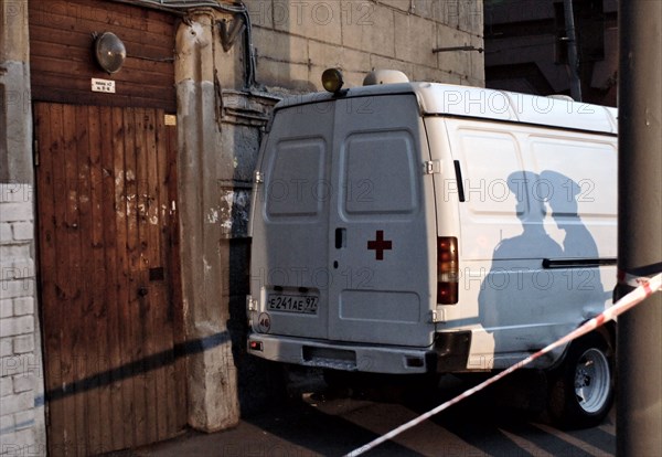 Tv camera lights cast long shadows onto the entrance of the apartment building where russian journalist, the novaya gazeta special correspondent anna politkovskaya was killed, moscow, russia, october 7, 2006.