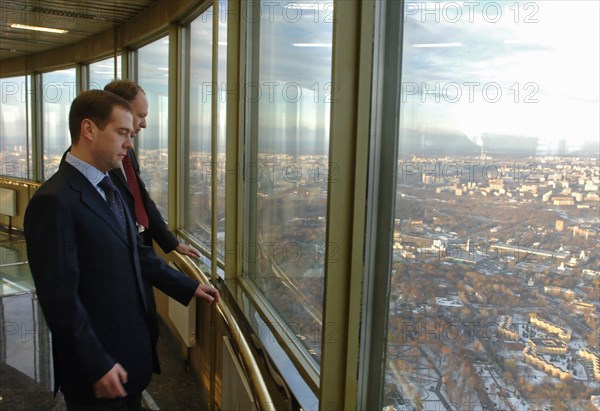 Head of russia's federal press and mass communications agency mikhail seslavinsky and russian first deputy prime minister dmitry medvedev, foreground, look at the city from ostankino tv tower observation platform prior to a meeting to discuss tv broadcasting issues,  moscow, russia, october 30, 2006.