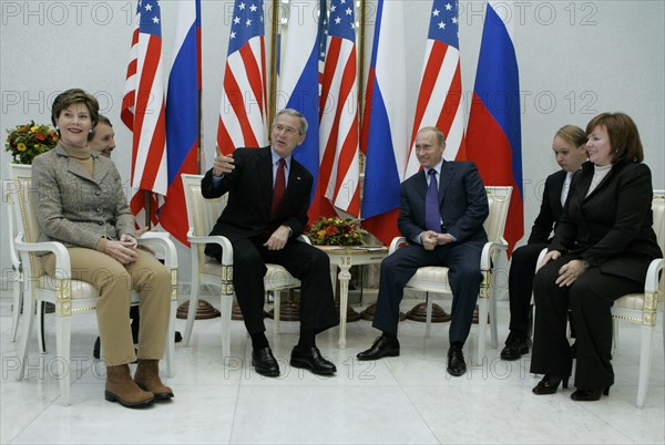 U,s, first lady laura bush, u,s, president george bush, russian president vladimir putin, and russian first lady lyudmila putina, l-r, foreground, smile at a meeting at the vnukovo 2 airport, moscow region of russia, november 15, 2006.