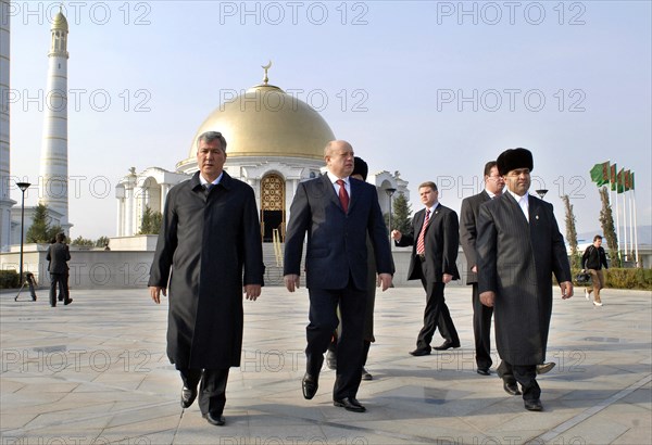 Ashgabat, turkmenistan, february 15, 2007, russian prime minister mikhail fradkov (c) walks after visiting the grave of president of turkmenistan saparmurat niyazov at the mosque called spirit of turkmenbashi.