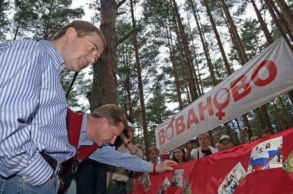 Russia's first deputy pms dmitry medvedev and sergei ivanov, l-r, view photos while on a visit to the summer camp of the pro-putin nashi (our people) youth movement at the lake seliger resort, tver region, russia, july 21, 2007.
