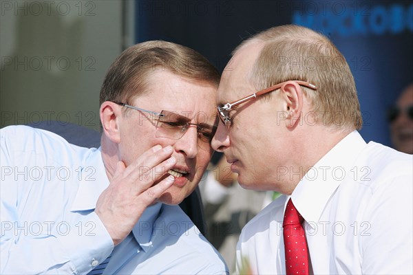 Russian first deputy prime minister sergei ivanov (l) and russian president vladimir putin talk at the opening ceremony of the 8th international aviation & space salon maks 2007  in the town of zhukovsky, moscow region of russia, august 17, 2007.