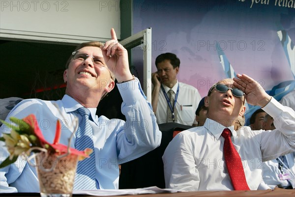 Russian first deputy prime minister sergei ivanov, russian president vladimir putin (l-r) watch the airshow at the opening ceremony of the 8th international aviation & space salon maks 2007 in the town of zhukovsky, moscow region of russia, august 17, 2007.
