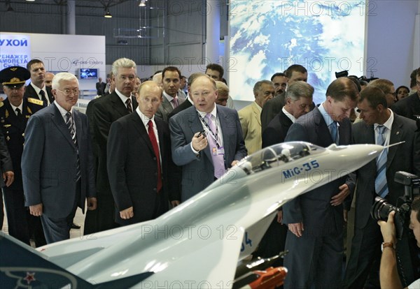 Russian president vladimir putin, head of the united aircraft building corporation, alexei fedorov, l-r, foreground, view a model of mikoyan mig-35 fighter at the 8th international aviation & space salon maks 2007 in the town of zhukovsky, moscow region of russia, august 17, 2007, pictured second from left, background, is putin's chief of staff sergei sobyanin; pictured second from right, background, is russia's first deputy pm sergei ivanov.