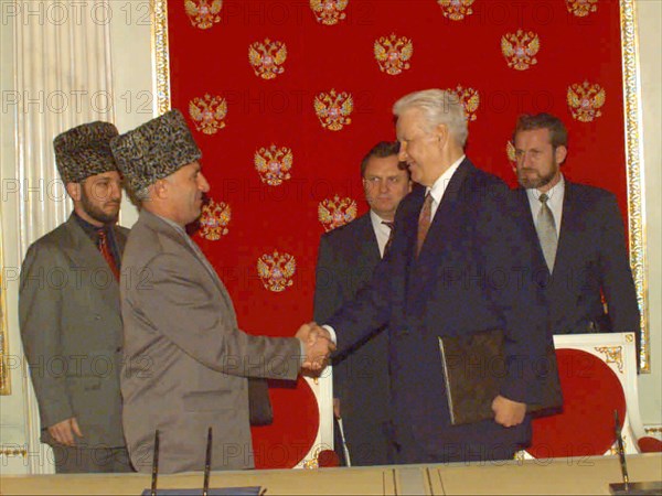 A treaty on peace and principles of mutual relations between the russian federation and the chechen republic of ichkeria has been signed today, on may 12, 1997 by president boris yeltsin and chechen leader aslan maskhadov, the picture shows the presidents shaking hands after the signing, in the background is russian security secretary ivan rybkin /centre/ , chechen vice-premier movladi udugov /left/ and chechen president's aide for national security akhmed zakayev /right.