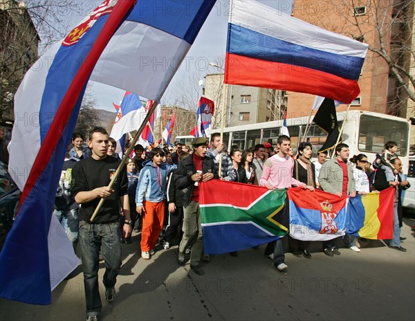 People hold a rally in a street in the town of mitrovica, a town of 60000 people, which the serbs have cut in two, kosovo, february 25, 2008.