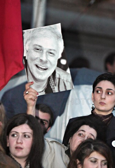Tbilisi, georgia, march 24, 2008, opposition supporter holds a picture of late businessman badri patarkatsishvili during a protest outside the parliament building in tbilisi, in support of opposition broadcaster imedi tv.