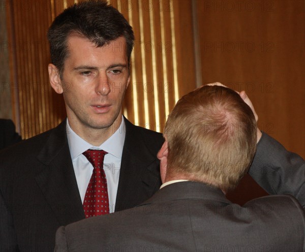 Moscow, russia, october 16, chairman of the board of polyus gold company, onexim group's owner mikhail prokhorov (background) attends a meeting of the organising committee to prepare for the nanotechnology international forum.