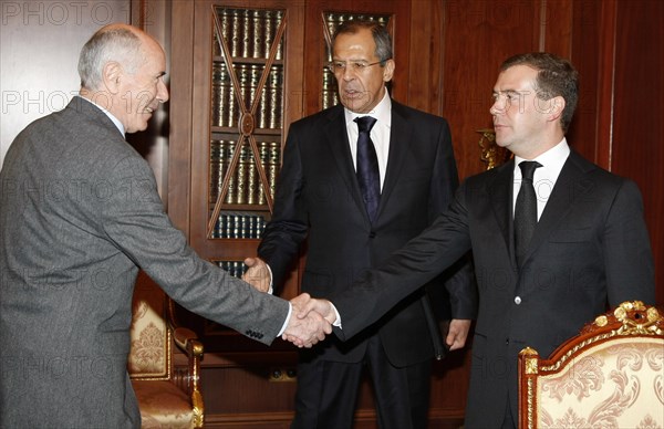 Russian president dmitry medvedev (r) and newly-appointed ambassador to south ossetia, elbrus kargiyev (l), shake hands as russian foreign minister sergei lavrov looks on during a meeting in moscow's kremlin, october 24, 2008.