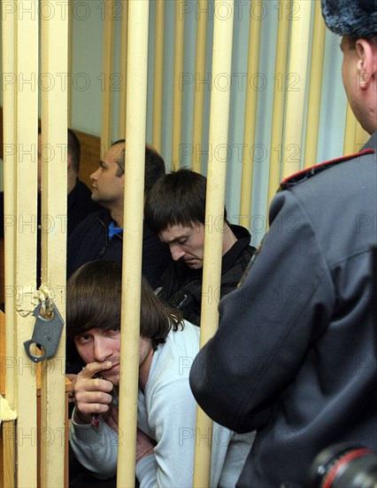 Suspects of murder of journalist anna politkovskaya, dzhabrail makhmudov (foreground), sergei khadzhikurbanov and ibragim makhmudov (l-r, background) appear at the hearing of moscow district military court, moscow, russia, november 17, 2008.