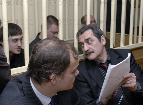 Dzhabrail makhmudov, pavel ryaguzov and sergei khadzhikurbanov (l-r, background), accused of murdering anna politkovskaya, novaya gazeta columnist, appear at the hearing of moscow district military court, moscow, russia, december 2, 2008.