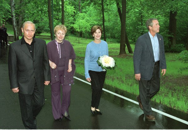 U,s, president george w, bush (r), first lady laura (2r), russian president vladimir putin (l) and his wife lyudmila (2nd l) pictured strolling in the grounds of the presidential residence at novo-ogaryovo on the outskirts of moscow on friday, may 24, 2002.