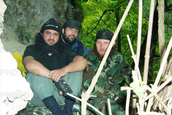 Moscow, russia, july 26, 2002, khattab's right-hand man isayev, aka the 'elsi the red', achimez gochiyayev, khattab (r-l) seen in the photo made public by the federal secirity service