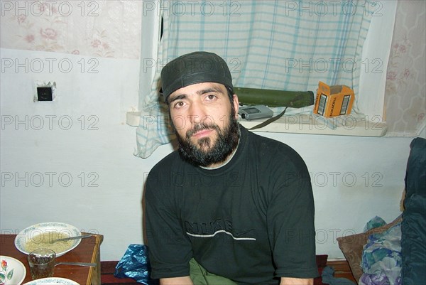 Moscow, russia, july 26, 2002, achimez gochiyayev, the prime suspect in the organization of explosions of residential houses in moscow and volgodonsk, pictured at the chechen gunmen's camp in chechnya on the photographs made public by the federal secirity service (fsb) today, this image was copied from a personal computer of the notorious field commamder rivaz chitigov captured in the course of a special operation of the federal security forces, (fsb public relations department photo).