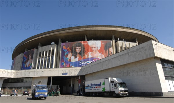 Moscow, russia, april 23, 2009, a huge billboard bearing the logo of 2009 eurovision song contest is installed on the outside wall of olimpiysky sports complex in central moscow.
