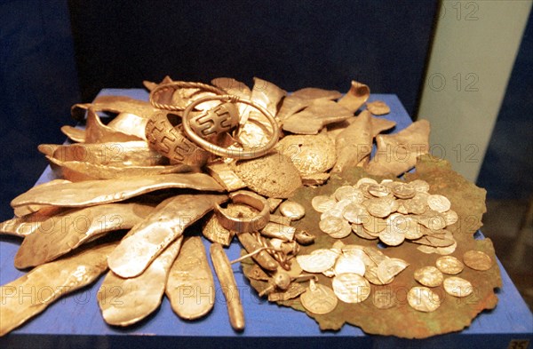 Coins and othr recovered objects from a hidden treasure of the 12th century, russia, 2001.