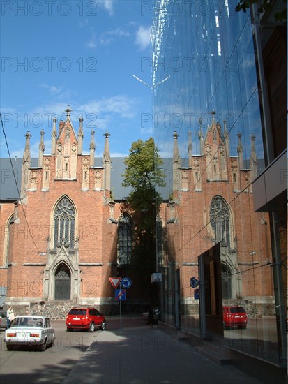 Riga, latvia, 2003, the lutheran gertruda's church in baznicas street beside a modern multi-storey car park, park.