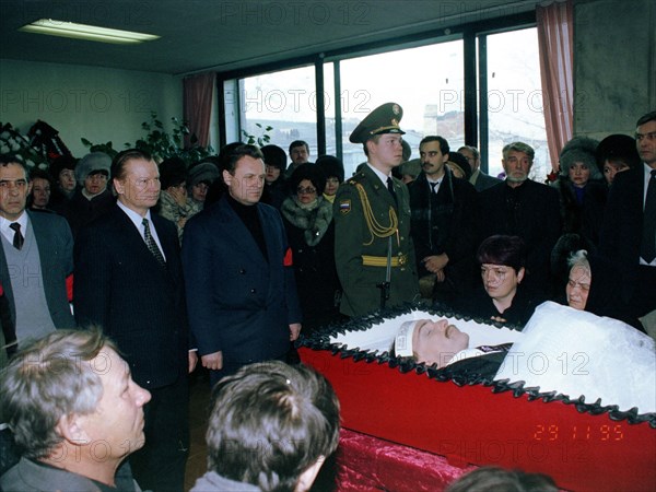 Chairman of state duma ivan rybkin standing center behind coffin at funeral in chita of deputy to the state duma sergey markidonov, killed by hired gunmen on november 26 in the city of petrovsk-zaballkalsky, russia, 1995.