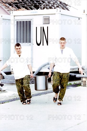 Russian paratroopers carrying a saucepan with soup from the uno, croatia, 1997, the russian peace-keeping batallion in klisa will be the last united nations forces to be withdrawn from croatia.