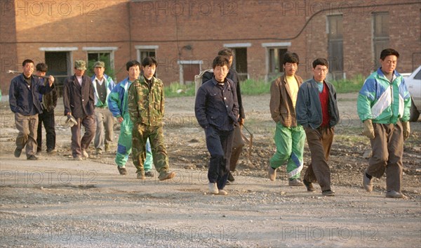 Chinese workers are heading to a construction site in the city of ussurllsk (russian far east) early in the morning, maritime territory,russia,october 12 1998, due to the recent economic crisis in russia the amount of foreign labourers here has a tendency to diminish because they receive for the same sum of roubles less dollars than before and this is the only currency they prefer to take home.