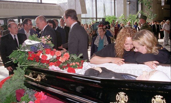 Daughters seen grieving by the coffin of oleg belonenko, director general of russia's uralmash machine-building giant