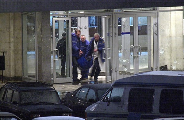 Moscow, russia, october 26 2002: chechen hostage crisis, a dead body is carried out of the theater center, presumably it is the body of the man who entered the building tonight, probably a relative of a hostage.