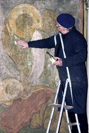 Restorer alexander nekrasov restoring a fresco by andrei rublyov at the assumption cathedral of vladimir, the frescos, included in the unesco world heritage list, are in critical condition now, as they are covered with fly ash of burning candles and there is no temperature and humidity control equipment at the cathedral, vladimir, russia, december 5, 2002.