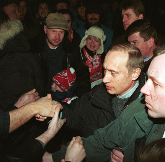 Acting president and prime minister vladimir putin (2nd from right) being greeted by football fans at moscow's luzhniki stadium on saturday when he came to watch a match between spartak moscow and alania vladikavkaz, moscow,russia, march 25 2000.