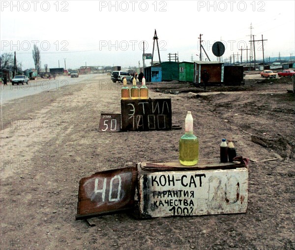 The illegally produced petrol is widely on sale on the verge of chechen roads, for the years of dudayev and maskhadov's governing over 15 thousands private mini-plants for oil processing into low-grade petrol were illegally built, as a result over 120 million tons of oil were looted at a total amount of 14 million dollars, a lot of mini-plants were eliminated during the special operations of the russian federal troops, grozny, chechnya, july 2000.