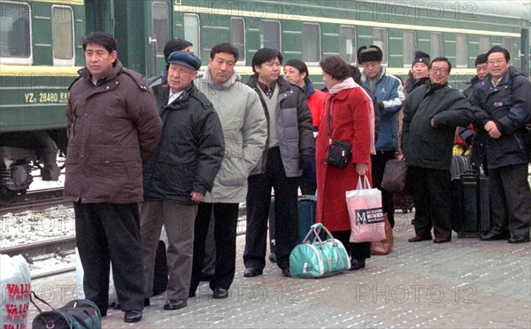 Russia, february 6, 2003: a regular group of chinese tourists has arrived at the station of grodekovo, russia's maritime territory