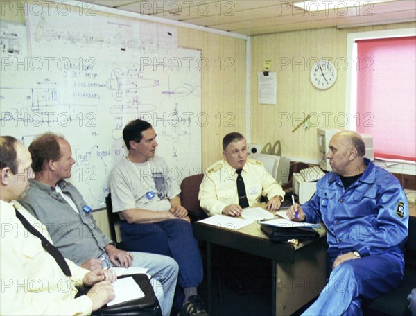 Barents sea, july 19 2001, head of diving work sean popple (r) and head of the team of russian divers gennady verich (r) aboard the mayo ship, located in the barents sea over wrecked sub 'kursk', russian divers should start operations to raise the kursk from the bottom in the nearest days.