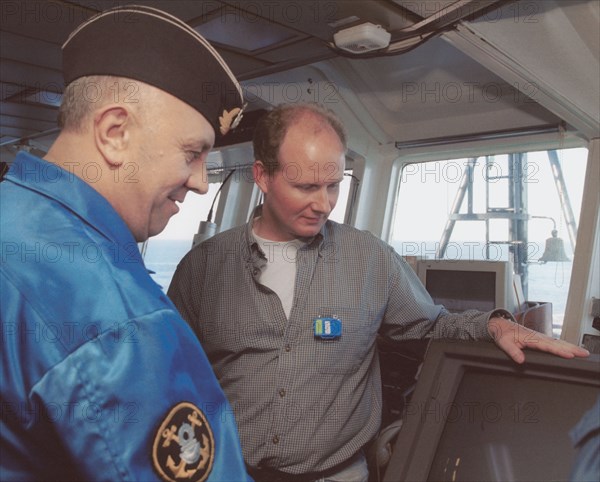 Barents sea, july 19 2001, head of diving work sean popple (r) and head of the team of russian divers gennady verich (r) aboard the mayo ship, located in the barents sea over wrecked sub 'kursk', russian divers should start operations to raise the kursk from the bottom in the nearest days.