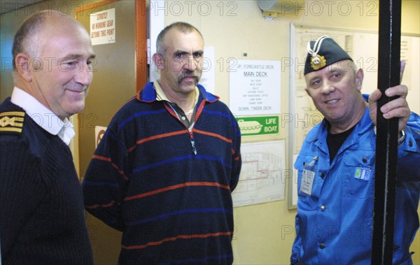 barents sea, russia, august 26 2001, captain of the 'mayo' special vessel robert greenwood, head of the diving works reimand wallace and chief of the group of divers, rear-admiral gennady verich ( all l-r) pictured talking on board of the mayo ship as divers have resumed their work on saturday in prepation to 'kursk' sub's lifting, due to favorable weather conditions,  26,08,2001 .