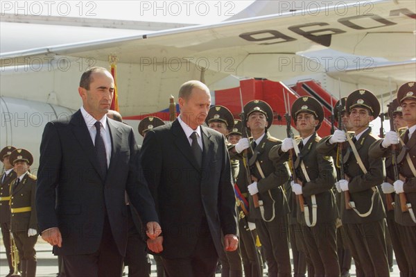 Russian president vladimir putin (r) and his armenian counterpart robert kocharyan (l) inspecting guard of honour upon the arrival of russian head of state at the airport of yerevan on friday sept, 14, 2001.