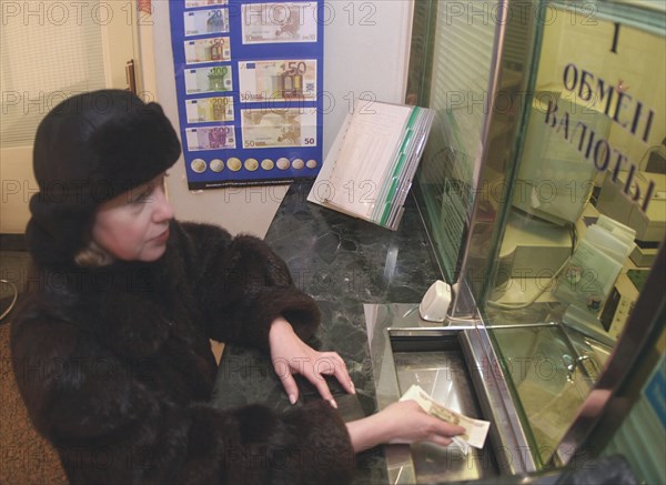 Moscow, russia, january 3 2002, a customer purchasing euro notes from a bank, as today, thursday, the first office day of the new year, the new single european currency is available at russian banks.