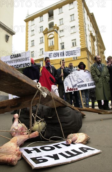Moscow, russia, march 22 2002: participants of a rally in front of the american embassy protesting import of chicken leg quarters from the u,s,a, about a dozen youngsters took part in the rally, the poster reads: 'no to chicken blindness! (the corresponding russian for night blindness)'.