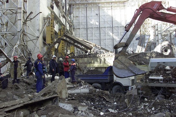 Baikonur, kazakhstan, may 14 2002: devastating fire at energia works: workers clearing debris of the destroyed roof of the assembly and test block where rocket-carrier 'energia' and russian space-shuttle 'buran' were stored before the fire.