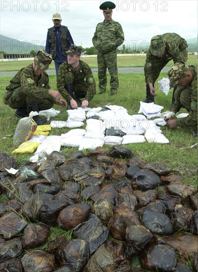 Russian borderguards on the tajik-afgan frontier - tajikistan , may 27, 2002, picture shows russian borderguards seized a large load of drugs from the trafficers on the tajik-afgan frontier, about 700 kilograms of drugs were seized by russian border-guards on the tajik-afghan border from the beginning of the year,and about 17,3 tons of different narcotics including 4,2 tons of heroin were confiscated by the russian borderguards since the beginning of their service at the tajik-afgan frontier .