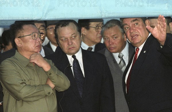 North korean leader kim jong-il (l) listens to explanations of the president of the jsc 'vladivostok commercial seaport' mikhail robkanov (r), at the port on friday, 8/23/02, a special awning was erected here to protect the honourable guest from the heavy rain, second right is vladivostok mayor yuri kopylov.