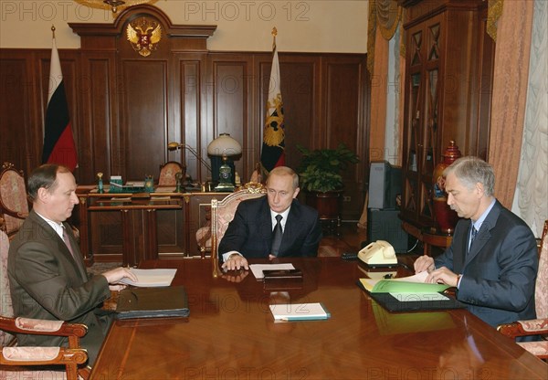 Moscow, russia, october 24 2002: russia's federal security service (fsb) director nikolai patrushev (l) and interior minister boris gryzlov (r) pictured reporting the hostage situation developments in downtown moscow to president vladimir putin, (c) during the meeting in the kremlin on thursday.