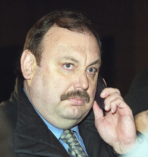 Moscow, russia, october 25, 2002: a member of the state duma's security committee gennady gudkov speaks over the telephone outside the dubrovka theatrical center where hostages are held by chechen terrorists, on thursday.