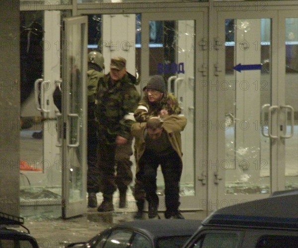 Moscow, russia,10/26/02: chechen hostage crisis: special forces personnel escort a terrorist out of the building, barayev and 35 terrorists including those with explosives attached to their bodies, were killed, the hostages are free.