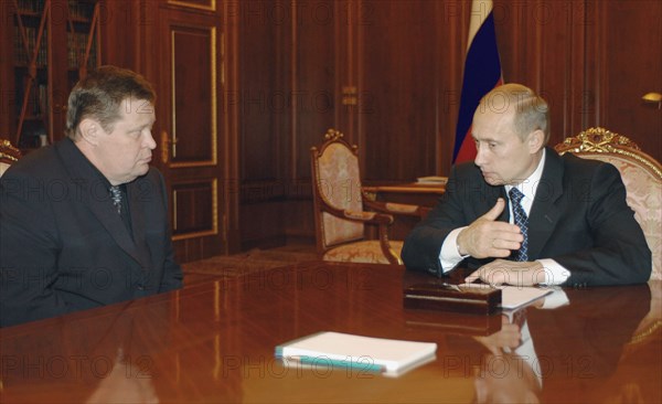 Moscow, russia,10/26/02: chechen hostage crisis: president vladimir putin (r) had a meeting with prosecutor general vladimir ustinov (l) who reported that all the matters related to the crime will be investigated comprehensively.