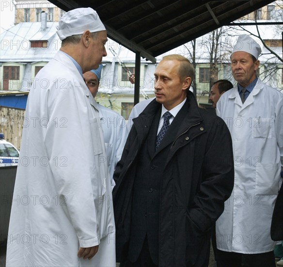 Moscow, russia,10/26/02: chechen hostage crisis: president vladimir putin (c) talks to doctors, president visited released hostages in need of medical attention who were taken to the sklifosovsky first aid hospital.