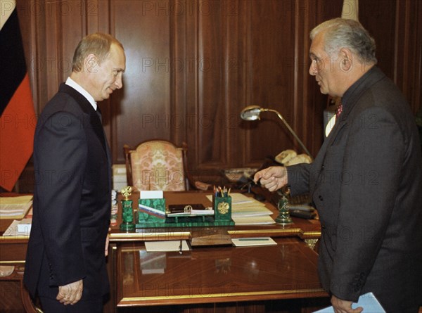 Moscow, russia, october 28 2002: president of russia vladimir putin (left) holding a meeting with pediatric surgeon leonid roshal (right) on monday in the kremlin, at the meeting putin thanked roshal and all those who helped the people recently held hostages in moscow.
