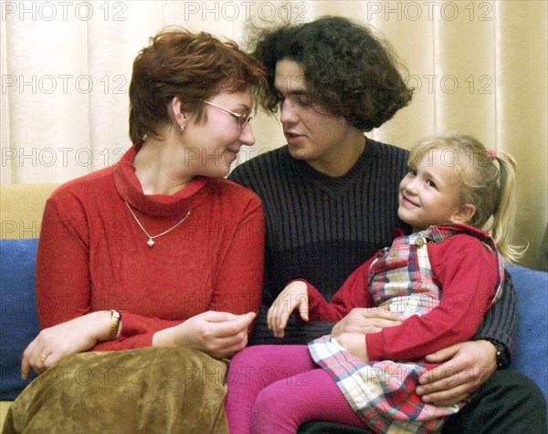 Yaroslavl, russia, october 30 2002: the tokmakovs family, (from left) larisa, vitaly and tamara, were among the audience of the popular nord-ost musical, when they were taken hostage at the dubrovka theatrical centre in moscow, 5-year old tamara (right) were let go earlier, after negotiations, now the freed and reunited family returned to their home city after treatment in moscow hospitals.