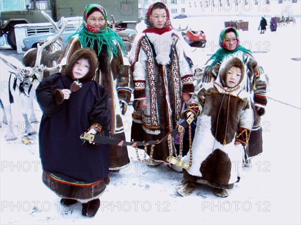 Komi reindeer breeders, siberia, russia, 11/02, komi women who live in a subpolar region wearing sweaters made of reindeer fur which is a traditional outer clothing of tundra women, children display crafted traditional belt.