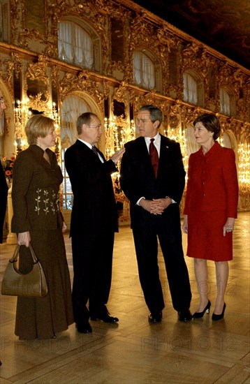 Leningrad region, russia, november 22 2002: president of russia vladimir putin (2nd l) and president of the usa george bush (2nd r) and their wives lyudmila (l) and laura (r) in one of the halls of the katherine palace of the historical tsarskoye selo near st,petersburg, (photo sergei velichkin).