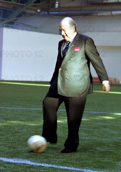 Minsk, belarus, december 8 2002: fifa president joseph blatter kicks a football (in pic) at a ceremony held on sunday to celebrate the opening of a football field with artificial covering, the field was created under the aegis of 'goal' programme financed by fifa, (photo viktor tolochko).